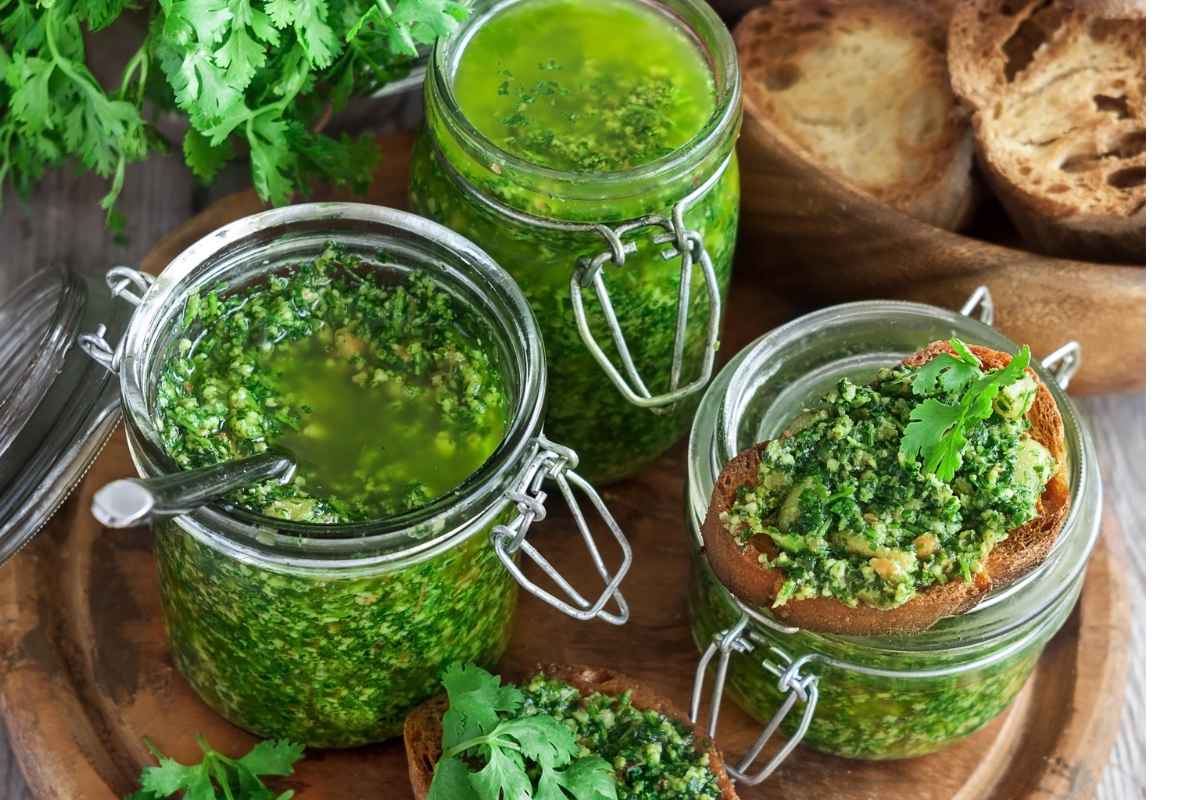 Barattoli di pesto su tagliere di legno